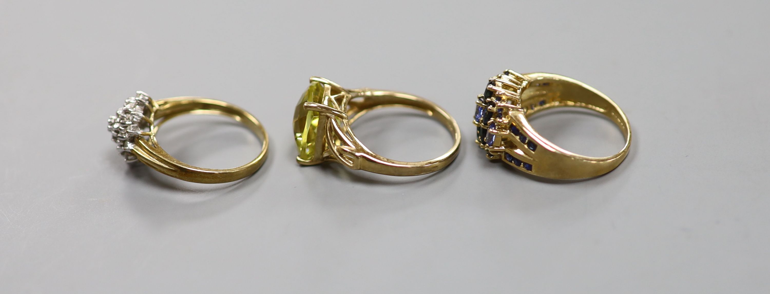A diamond and 9ct gold cluster ring and two other 9k rings